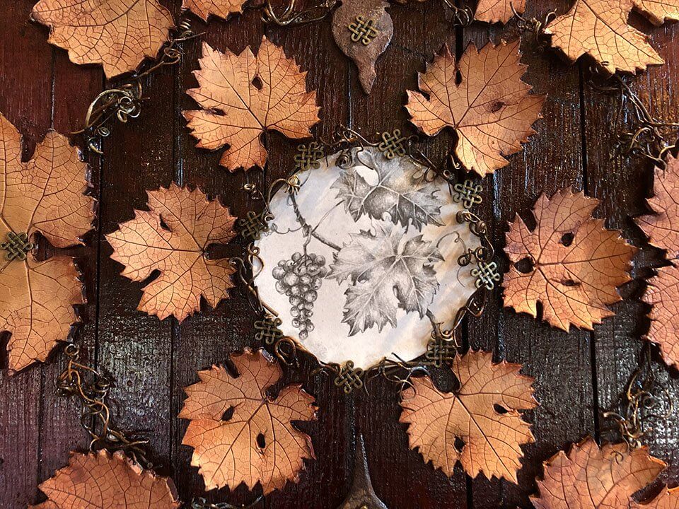 ArterraArtwork-LeavesOnStainedWoodenBGMetalicLace Arterra Wines Artwork Leaves On Stained Wooden background with Metalic Lace